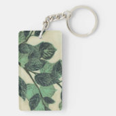Bladeren en vertakkingen op de achtergrond van Cre Sleutelhanger (achterkant)