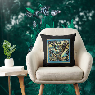  blauw en goudvlinder collage op zwart kussen