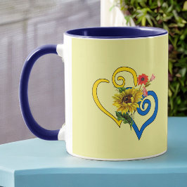 Blauw geel verdraaid hart met zonnebloem op geel mok