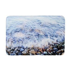 Blauw water en kleurrijke stenen badmat