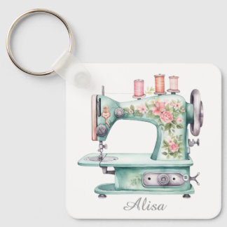Blauwe bloemensleutelhanger met naaimachine sleutelhanger