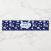 Blauwe en witte sneeuwvlokken op donkerblauwe gron waterfles etiket (Enkel label)