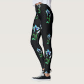 Blauwe groene neonbloemen op zwart leggings (Links)