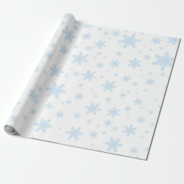 Blauwe sneeuwvlokken in het wit cadeaupapier