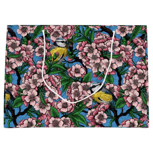 Blauwe stietvogels in de bloeiende kersenboom op b groot cadeauzakje (Voorkant)
