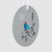 Blauwvogel kijkt naar een kerstsnowflake ornament (voorkant)