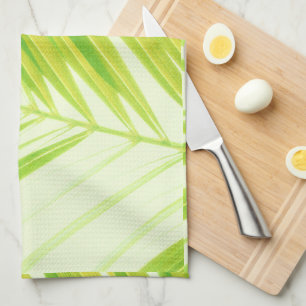 Bleke groene palmbladeren met pasta's theedoek