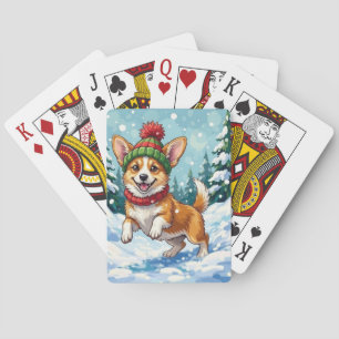 Blijde Corgi-hond die in de sneeuw springt met Pom Pokerkaarten