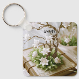 Bloeiende boom groeien uit een aangepaste boek sleutelhanger