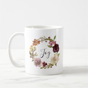 Bloemenschildering met krans en het woord Joy Koffiemok