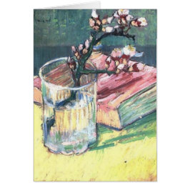 Blossombere amandeltak in een glas en een boek