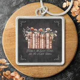 Boeken met bloemen en citaat op zwart schoolbord sleutelhanger