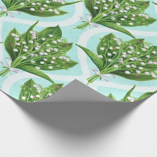 Boeket van lelie van de vallei bloemen op blauw cadeaupapier (Hoek)