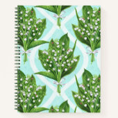 Boeket van lelie van de vallei bloemen op blauw notitieboek (Voorkant)
