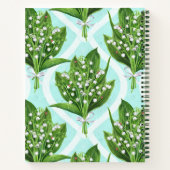 Boeket van lelie van de vallei bloemen op blauw notitieboek (Achterkant)