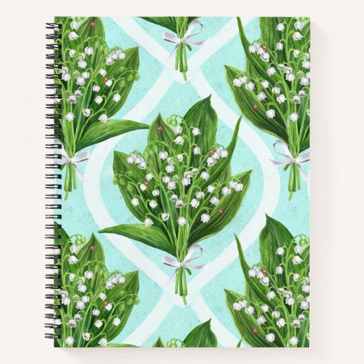 Boeket van lelie van de vallei bloemen op blauw notitieboek (Voorkant)