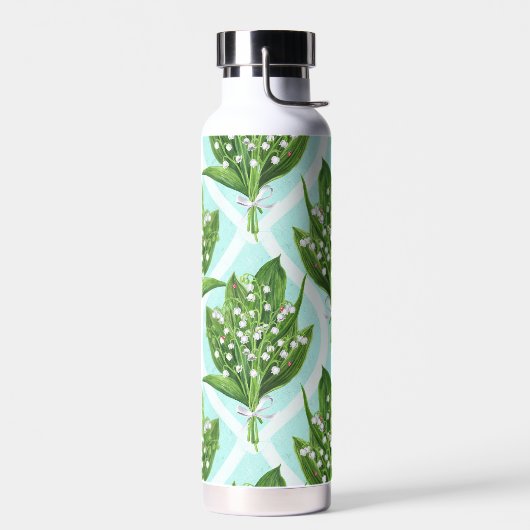 Boeket van lelie van de vallei bloemen op blauw waterfles (Links)