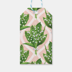 Boeket van lelie van de vallei bloemen op roze cadeaulabel