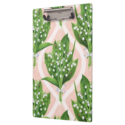 Boeket van lelie van de vallei bloemen op roze klembord (Links)