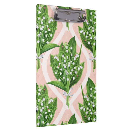 Boeket van lelie van de vallei bloemen op roze klembord (Rechts)