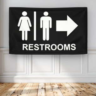 Bord met pijl richting toilet spandoek