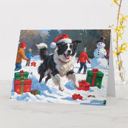 Border Collie in kerstmuts speelt in de sneeuw Kaart (Gele Bloem)