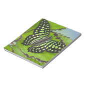 Boterfly op groen notitieblok (Linkerzijde)