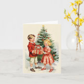 Boy and girl giving each other Christmas presents Kaart (Gele Bloem)