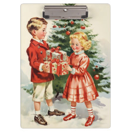 Boy and girl giving each other Christmas presents Klembord