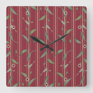 Branch of leaves on red wallpaper vierkante klok
