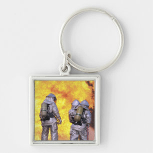 Brandblussers blussen een vliegtuig brand sleutelhanger