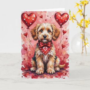Briard-valentijnshond zittend met rode harten kaart