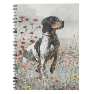 Brittany Spaniel jaagt in het veld Notitieboek