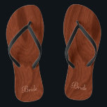 Bruid Trouwdag Rustiek Hout Look Strand Honeymoon Teenslippers<br><div class="desc">Rustieke houten look bruid flip flop thong sandalen perfect voor strand bruiloften leest bruid in elegante stijl, pastel roze letters aan de onderkant. Elegante, rijke mahoniehouten look houtnerf patroon achtergrond. Opmerking: Hout is bedrukt afbeelding. Rustieke bruiloft gunsten voor bruids partij leden. Verander gewoon tekst sjablonen om uw eigen gepersonaliseerde huwelijksfeest...</div>