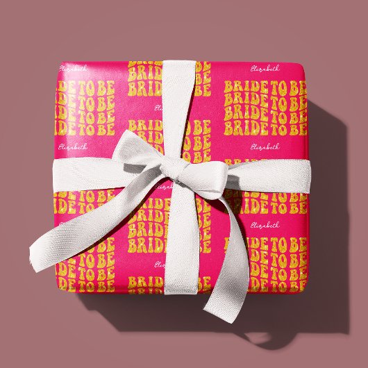Bruid wordt gouden glittertekst met naam, roze cadeaupapier