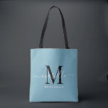Bruidsmeisje Gift Wit Zwart Monogram Dusty Blue Tote Bag<br><div class="desc">Deze bruidsmeisje canvas tas is voorzien van een handgeschreven wit en zwart script typografie monogram met moerassen op een stoffige blauwe achtergrond. Cadeau uw bruidsmeisjes met een tas voor het dragen van items op de dag van de bruiloft,  en traditioneel gepresenteerd tijdens het repetitiediner of daarvoor.</div>