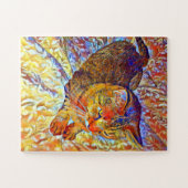 Bruine tabbykat die rust op een comfortabel bed legpuzzel (Horizontaal)