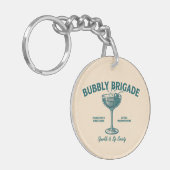 Bubbly Brigade Sparkle & Sip Genootschap Sleutelhanger (Voorkant Links)