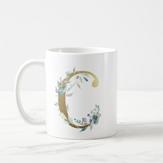 C goudinitiaal met blauw bloemblad koffiemok (Links)