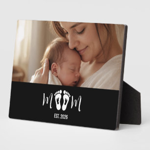 Cadeau met voetafdrukken van baby en oprichtingsda fotoplaat