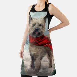 Cairn Terrier-hond in de sneeuw met Kerstmis Schort