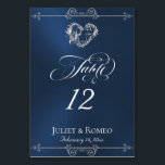 Calligraphy & Silver Heart - Blue Table Number Kaart<br><div class="desc">The design features an elegant blue background embellished with scroll borders, a heart and placeholders for the table number, couple's names and date of event. Available in several colors for your wedding theme. (Glitter is simulated in the artwork). Designed to coordinate with the Romantic Scroll Hearts & Calligraphy Wedding Collection....</div>