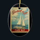 Cape May Sailboot Vintage Travel New Jersey Keramisch Ornament<br><div class="desc">Deze groeten van Cape May New Jersey hebben een zeemievormig ontwerp met een boot die op het water zeilt met zeemijlen en een blauwe hemel gevuld met prachtige witte wolken.</div>