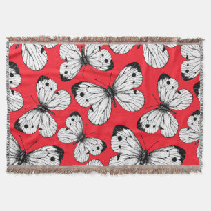 Carbisch vlinderpatroon op rood deken