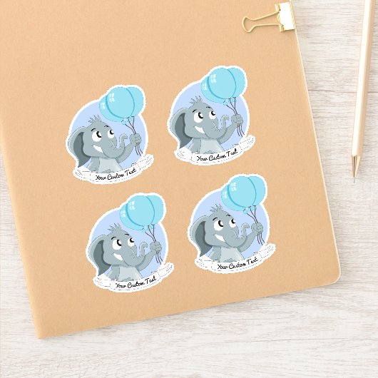 Cartoon olifant met blauwe ballonnen en een teksts sticker (Notitieboek)