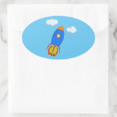 Cartoon ruimteraket in blauwe lucht ovale sticker (Tas)