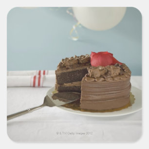 Chocoladecake met ontbrekende plak op tafel, vierkante sticker