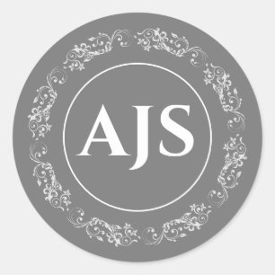 Cirkelvormig monogram in grijs en wit. ronde sticker