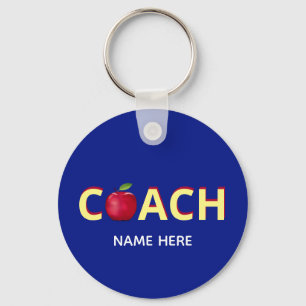 Coach tekst met rode appel op blauwe sleutelhanger