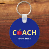 Coach tekst met rode appel op blauwe sleutelhanger (Voorkant)